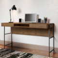 54" Industrial Desk made of wood and steel black legs with 2 drawers and 1 open storage area in a studio